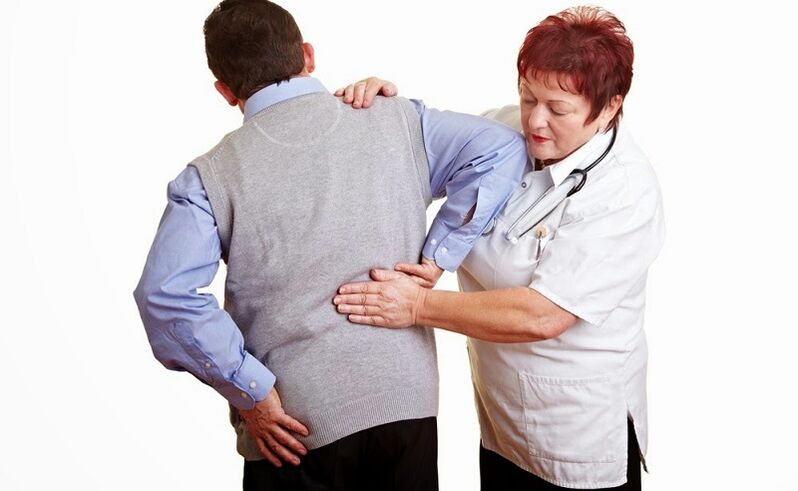 A doctor examines the patient for back pain